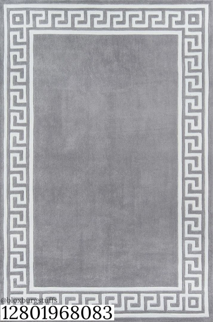 a gray rug with white greek border