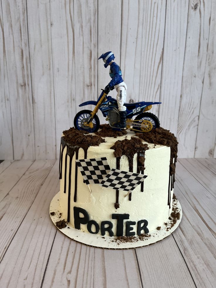 a birthday cake with a dirt bike on top