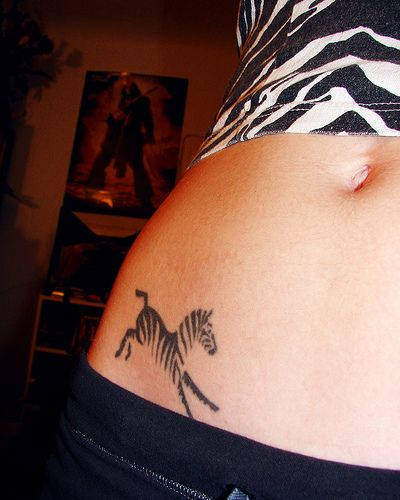 a woman with a zebra tattoo on her stomach