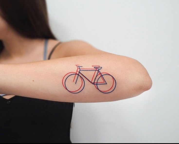 a woman with a bike tattoo on her arm