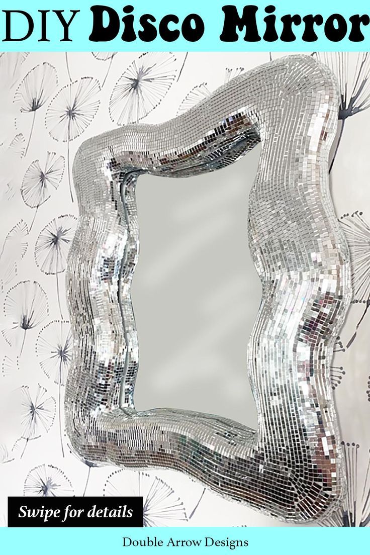 a mirror that has some kind of design on it's face and is made out of silver sequins