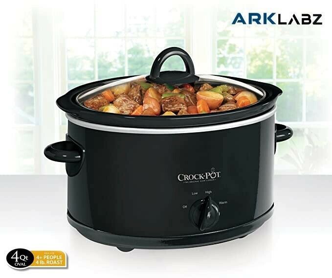 an electric slow cooker with food in it on a white countertop next to a window