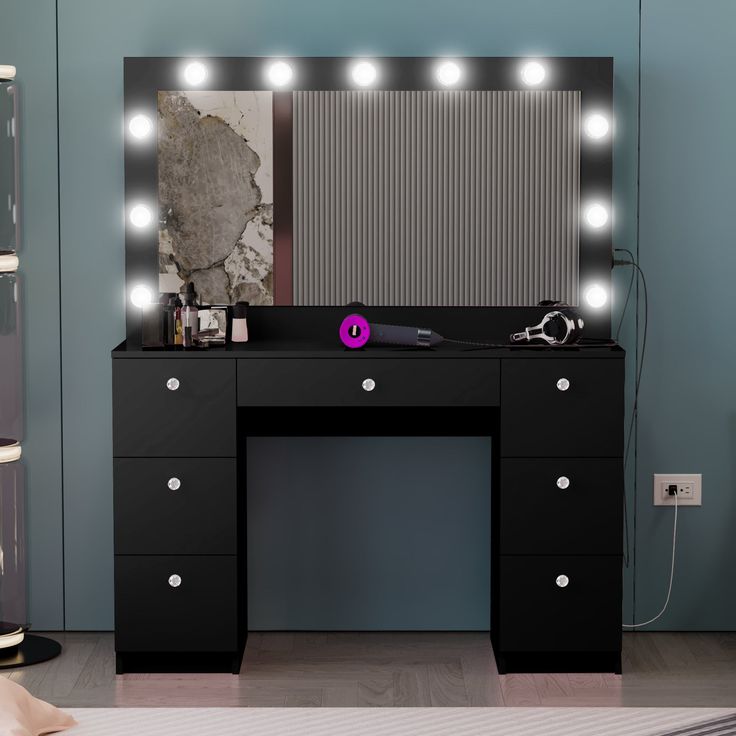 a black vanity with lights on it and a mirror behind it in a room that has blue walls