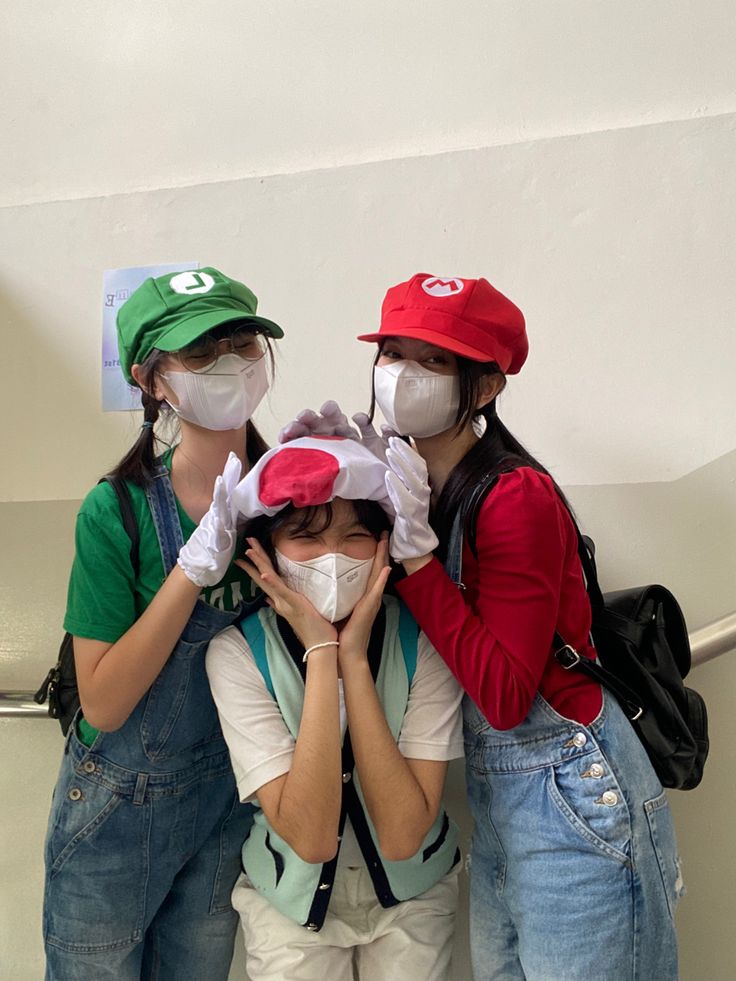 three girls wearing face masks while standing next to each other