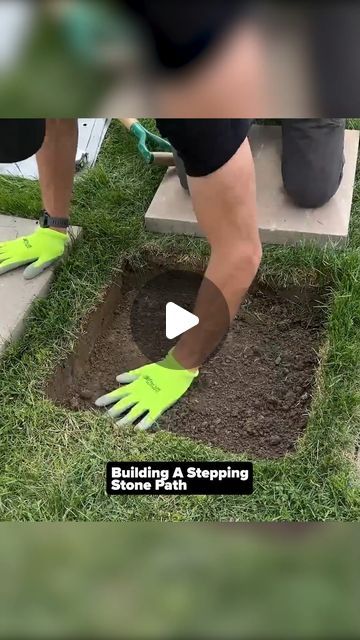 someone is digging in the ground with green gloves