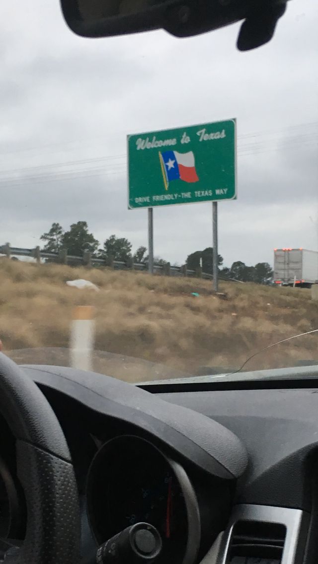 the view from inside a car looking at a highway sign