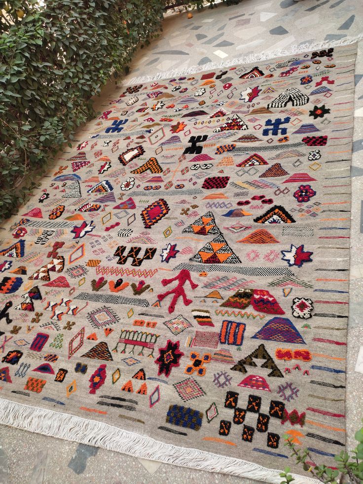 a multicolored area rug on the ground