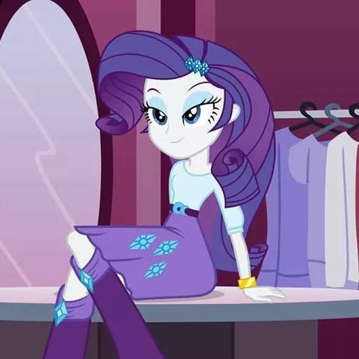 the pony is sitting on the table with her leg up in front of her face