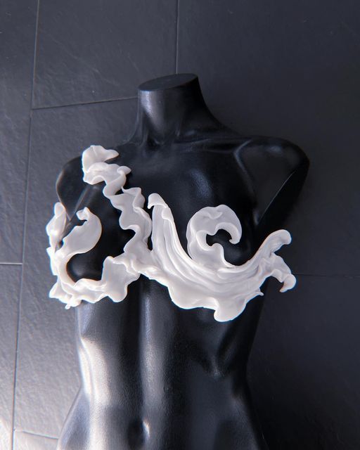 a black mannequin with white swirls on it's back and arms