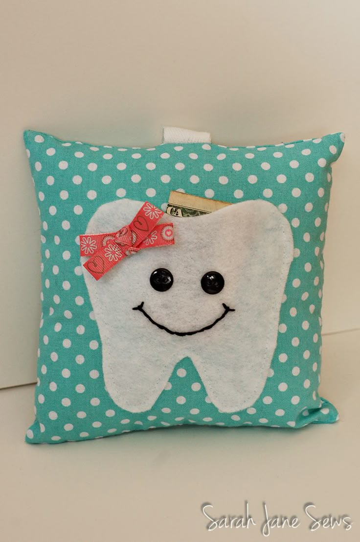 a tooth pillow with a bow on it