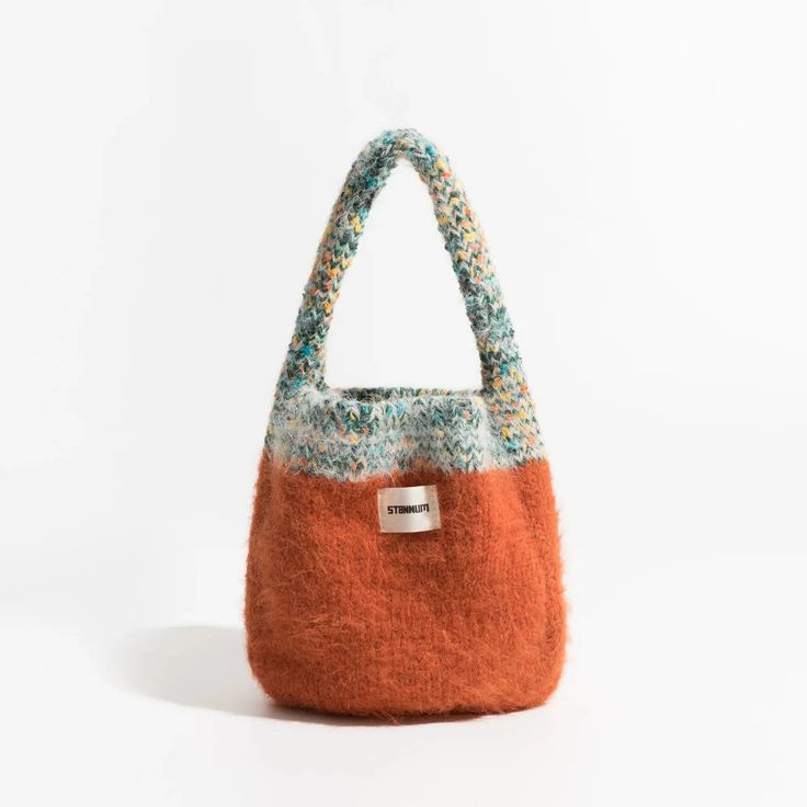 Add a touch of coziness to your style with the Multicolor Knitted Bucket Bag. The soft-touch knit material and plush texture make it a perfect handbag for casual and comfy occasions. Soft touch knit material Plush texture Handbag Size: length 16cm (6.2inc) width 5cm (1.9inc) height 20cm (7.8inc) Strap size: height 14cm Trendy Crochet Bag For Everyday Winter Use, Multicolor Rectangular Bags For Winter, Multicolor Rectangular Winter Bag, Winter Multicolor Rectangular Bags, Casual Crochet Bag For Everyday Winter Use, Casual Winter Crochet Bag For Everyday Use, Casual Soft Bags For Winter, Casual Knitted Bags For Winter, Winter Knitted Shoulder Bag For Everyday Use