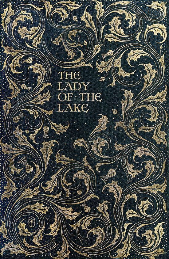 the lady of the lake is shown in green and gold foil on a black background