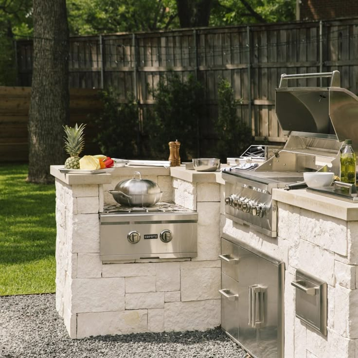 an outdoor kitchen with grill and sink