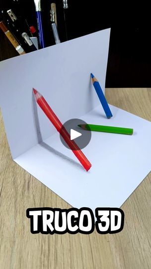 two pencils sticking out of a piece of paper with the words truco 3d on it