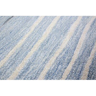 a blue rug with white stripes on it