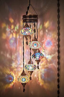 a chandelier hanging from the ceiling in front of a colorful background