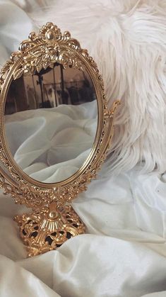 a mirror sitting on top of a white blanket