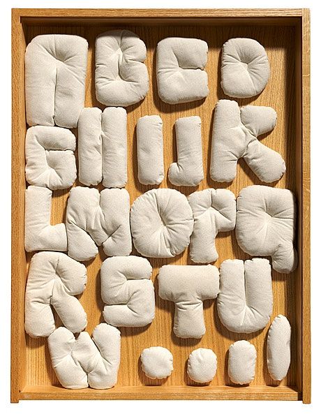 a wooden box filled with lots of white pillows