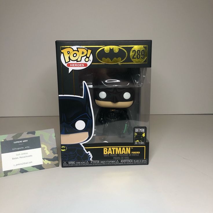 the batman pop vinyl figure is in its box next to it's package card