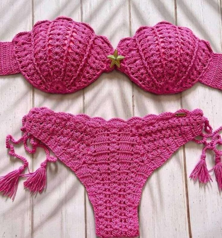 two pieces of pink crocheted bikinisuit with tassels