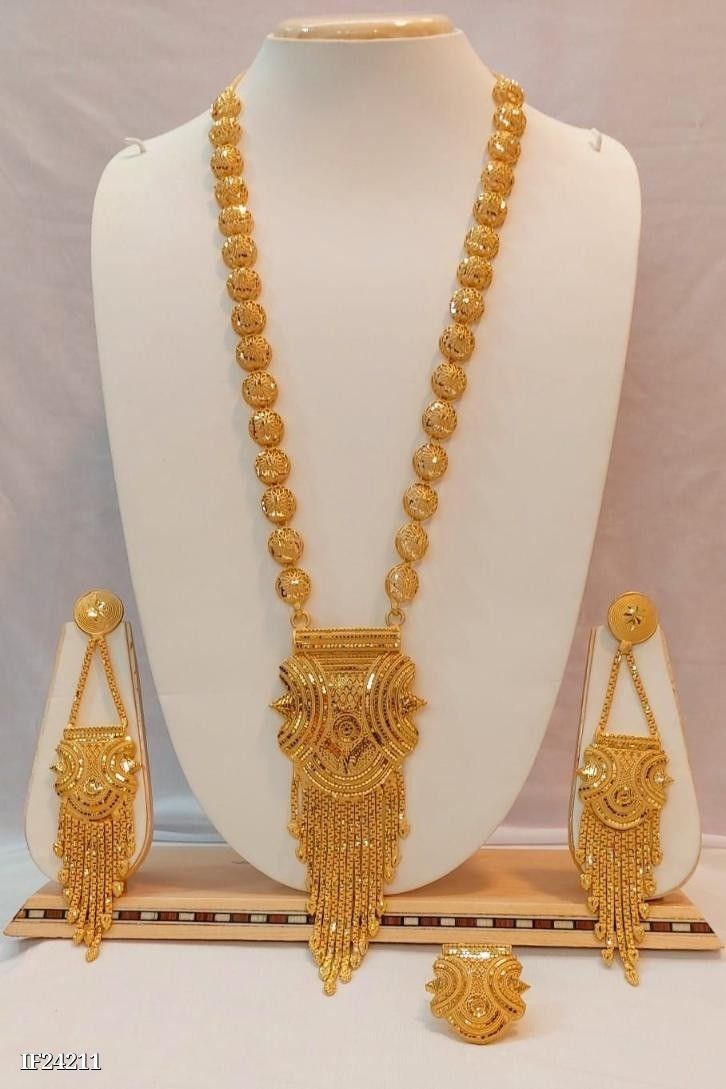 a gold necklace and matching earrings on display