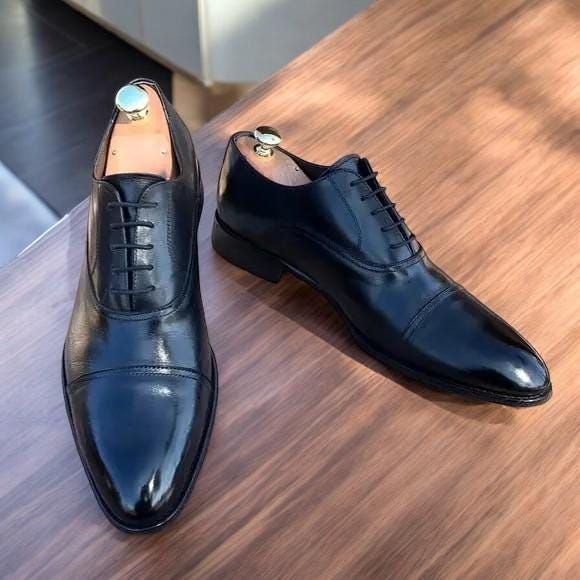 Black Patent Leather Shoes for Men are elegant and class, perfect for any formal occasion. Crafted from premium black patent leather, these dress shoes offer a sleek, high-gloss finish that complements your attire. Whether you're preparing for a wedding, a black-tie event, or a special night out, these shoes provide both comfort and a timeless look. They are the perfect addition to any gentleman's wardrobe with a durable construction and a classic design. 100% Original Handmade Premium Quality Leather Shoes & Boots Top Niche Features: - Detailed Stitching and Craftsmanship. - Leather Heel. - Soft Pre -Leather Lining. - 100% Leather Sole. - Ultra Comfortable - Sustainable and Eco-Friendly - Used for various Men's Dress Styles. For EU, UK, and USA sizes, please check the size chart in the pi Luxury Black Oxfords For Office, Luxury Black Dress Shoes For Office, Classic Black Leather Shoes For Party, Black Luxury Oxford Shoes, Luxury Fitted Loafers For Formal Occasions, Fitted Luxury Loafers For Formal Occasions, Black Cap Toe Leather Shoes For Semi-formal Occasions, Luxury Patent Leather Oxfords For Formal Occasions, Business Dress Shoes With Patent Leather And Leather Sole