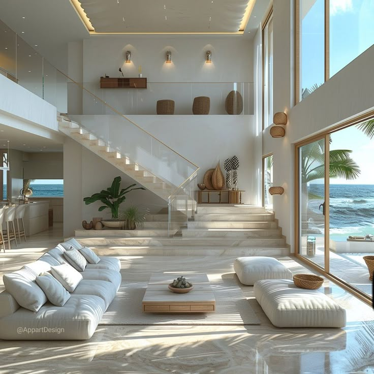 a living room filled with lots of furniture next to an ocean side house on the beach