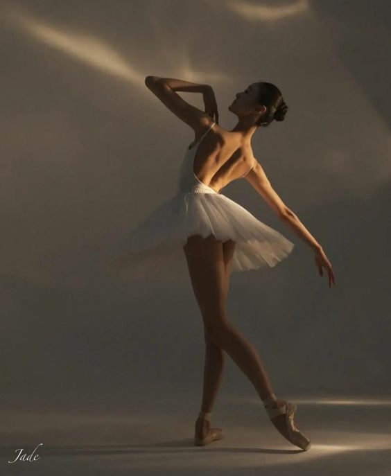 a ballerina in white tutu and ballet shoes