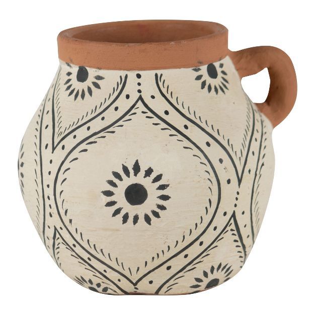 a white and brown vase with black designs on the outside, sitting against a white background