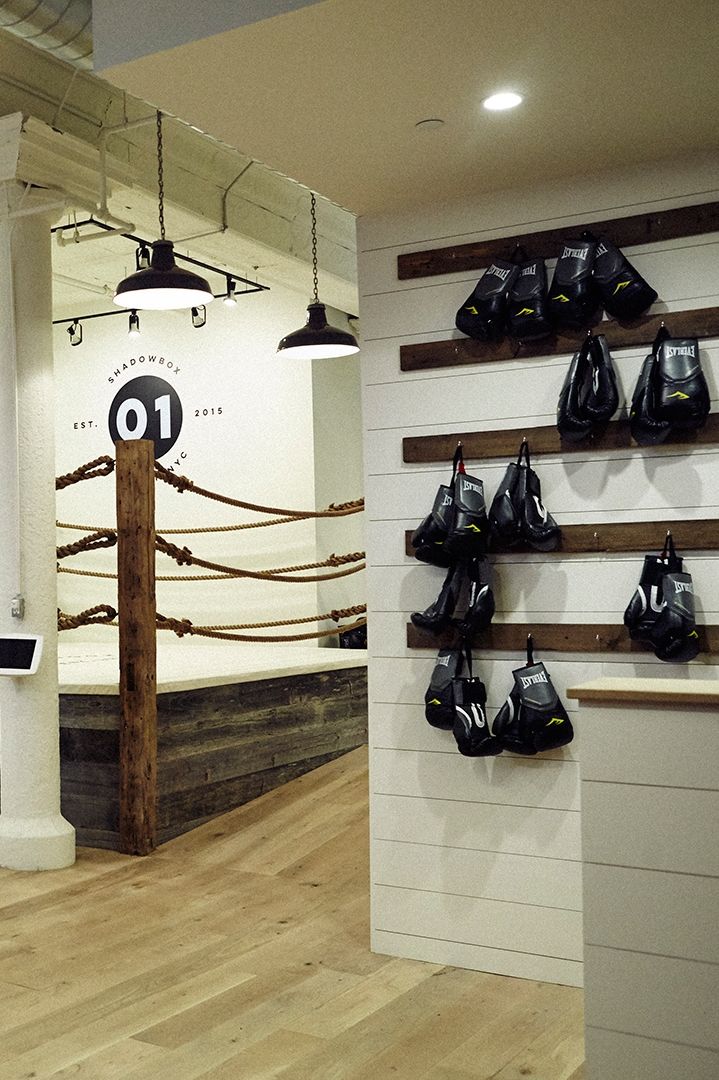 the inside of a boxing gym with black and white bags hanging on the wall,