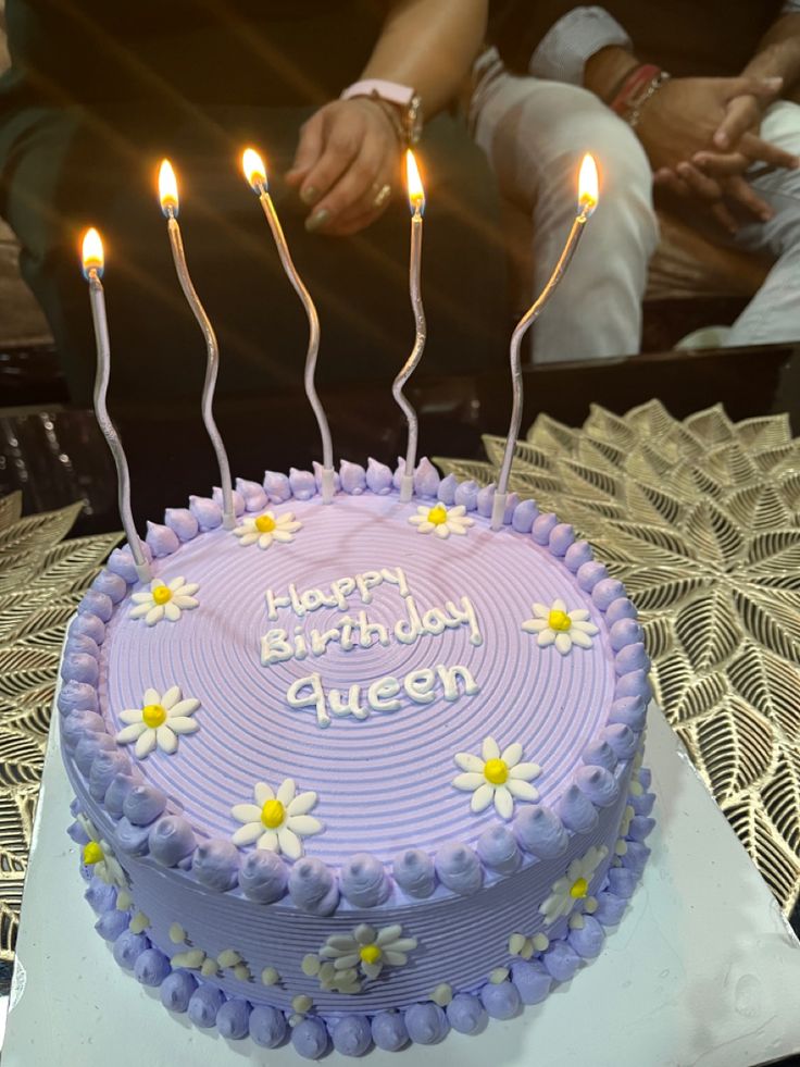 a birthday cake with three candles on it