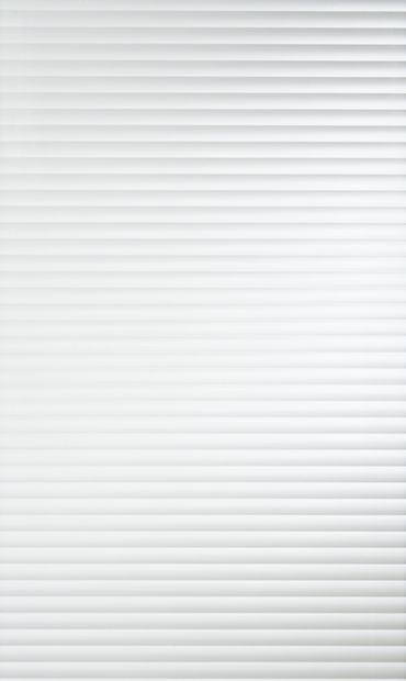 a white wall with vertical blinds on it