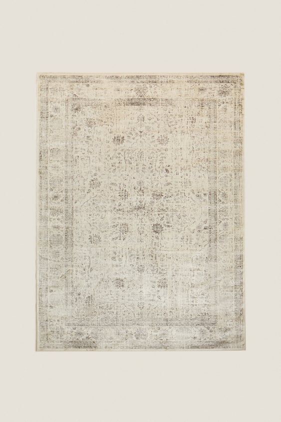 an antique rug with white and beige colors on the bottom, in a square shape