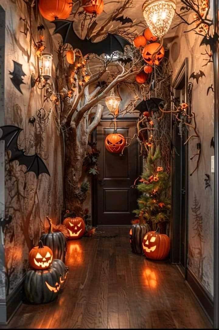 an entry way decorated for halloween with pumpkins and bats on the door, lights in the ceiling