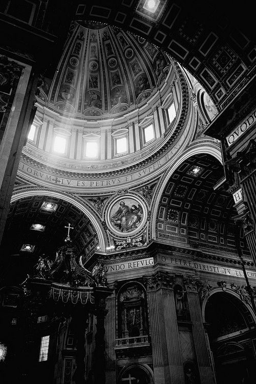 the inside of a church with an ornate ceiling and stained glass windows on each side