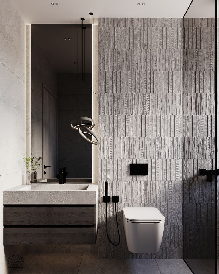 a bathroom with a white toilet sitting next to a sink under a faucet