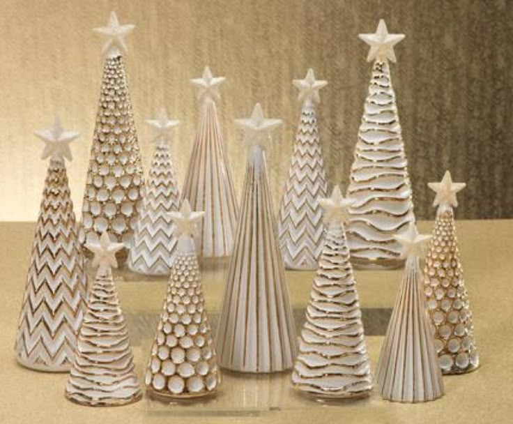 a group of paper christmas trees sitting on top of a table