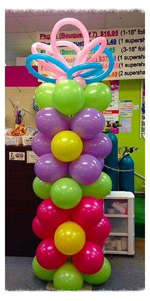 balloons are stacked on top of each other in the shape of a flower and butterfly