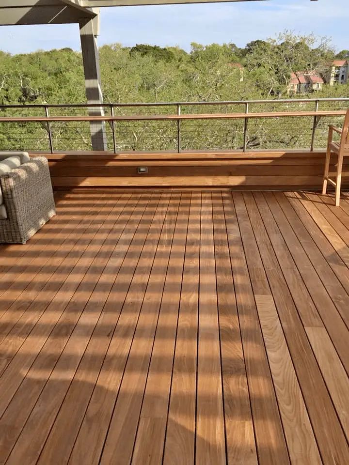 a wooden deck with two chairs on it