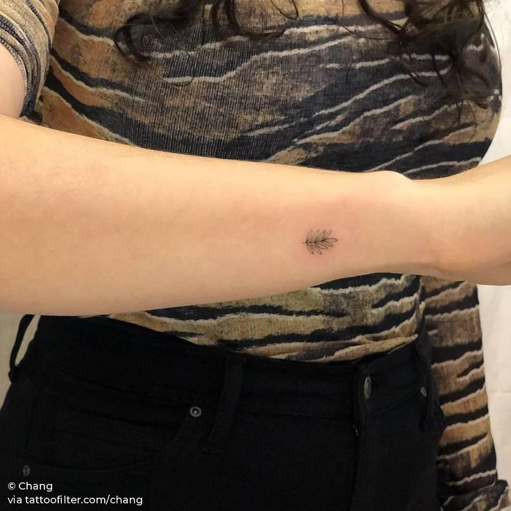 a woman's arm with a small tattoo on the left side of her arm