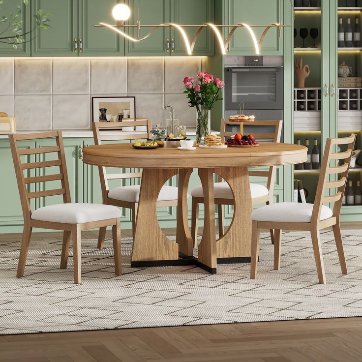 a kitchen table with chairs around it in front of green cabinets and an island area