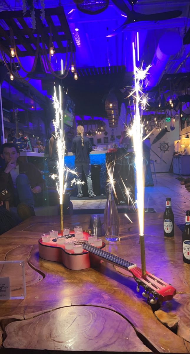 a wooden table topped with bottles and sparklers