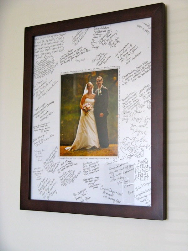 a wedding photo is framed in a wooden frame with many handwritten words on it