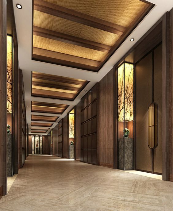 an empty hallway with wood paneling and decorative lighting on the ceiling is pictured in this rendering