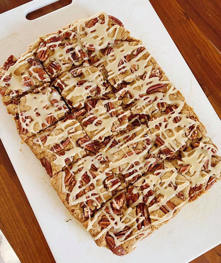 an uncooked pizza sitting on top of a cutting board