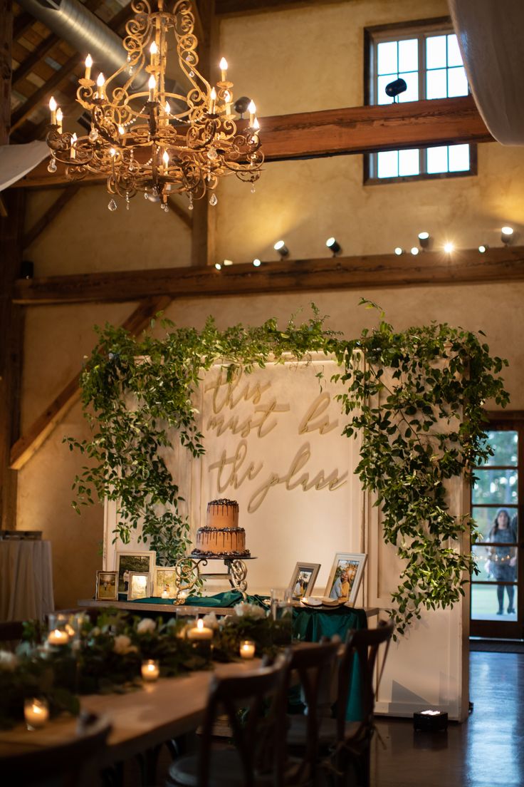 a table is set up with candles and greenery