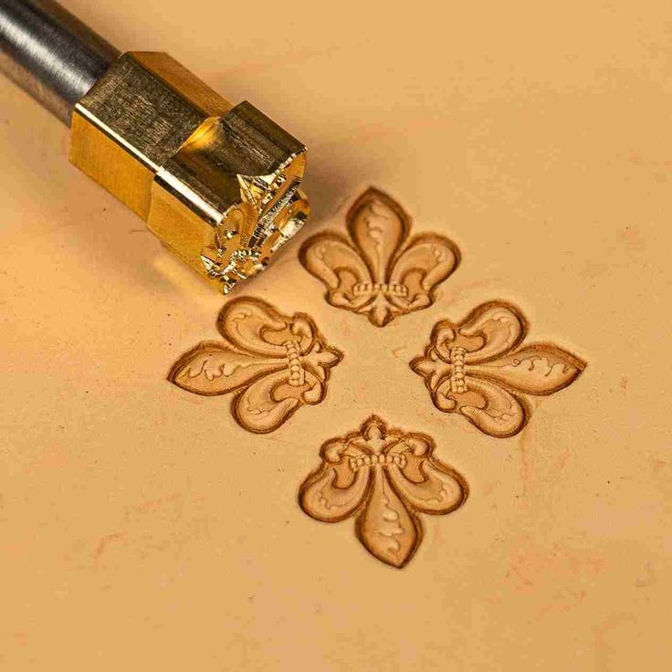 the stamp is being used to make some decorative designs on a piece of paper that has been carved into it