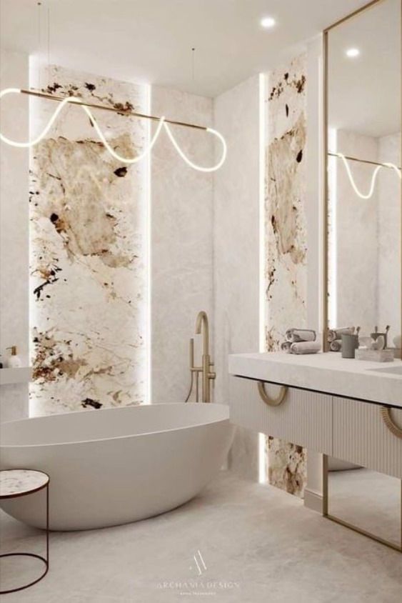 an elegant bathroom with marble walls and flooring is shown in this image, there are two sinks on either side of the bathtub