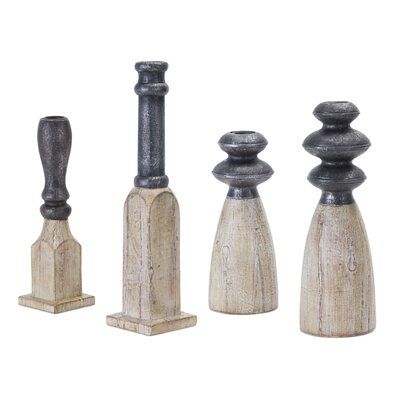 an assortment of wooden candlesticks on white background