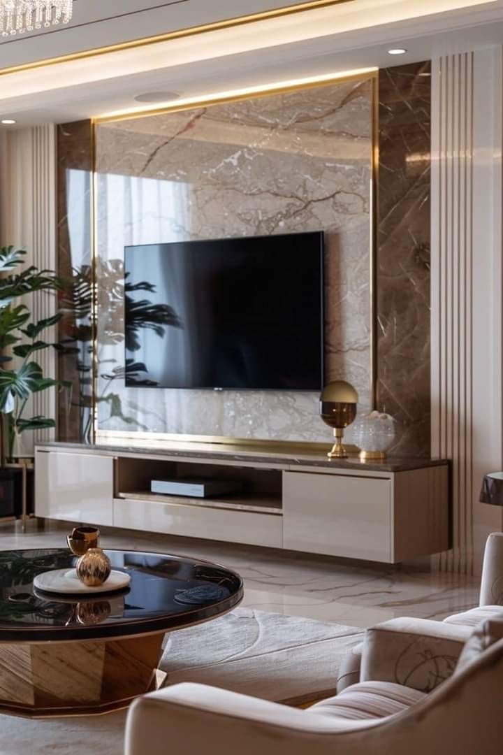 a living room filled with furniture and a large flat screen tv mounted on the wall